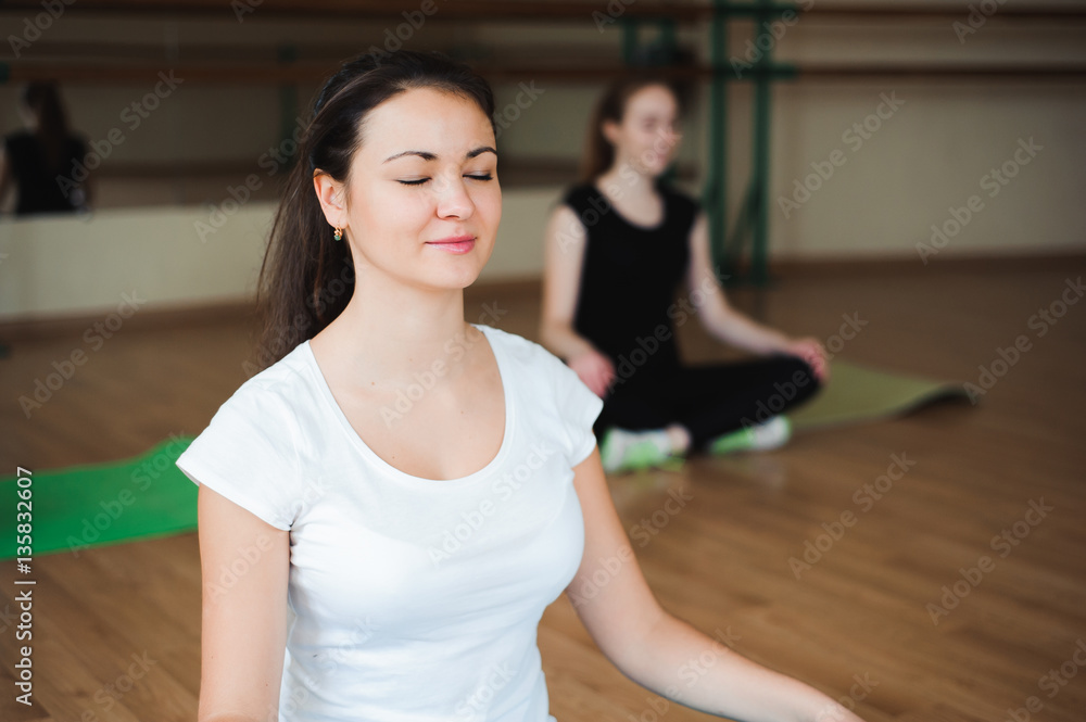 athletic woman doing relaxation exercises in gym class