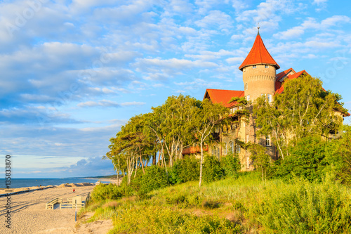 A view of Leba beach and historic hotel building on sand dune, Baltic Sea, Poland
