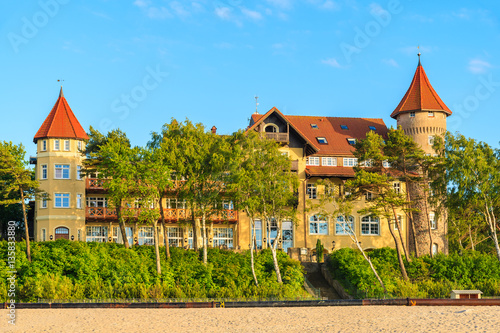 A view of Leba beach and historic hotel building on sand dune, Baltic Sea, Poland