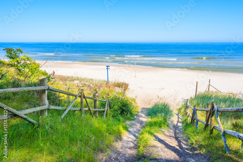 Path from forest to white sand beach on coast of Baltic Sea, Poland
