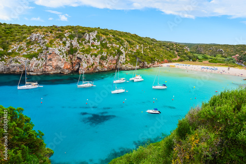 Sailing boats in beautiful bay of Cala Porter on Menorca island, Spain