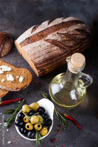 Fresh bread with olive oil and olives
