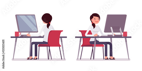 Young female clerk working at the computer, rear and front view