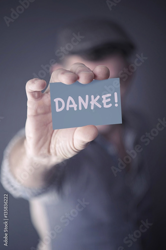 man showing card with german word for Thank You photo