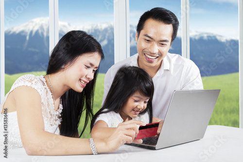 Cheerful family enjoying shopping online