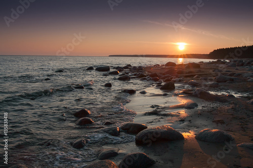 Sunset on the rocky beach © Yana