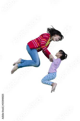 Mother and child leaping in studio