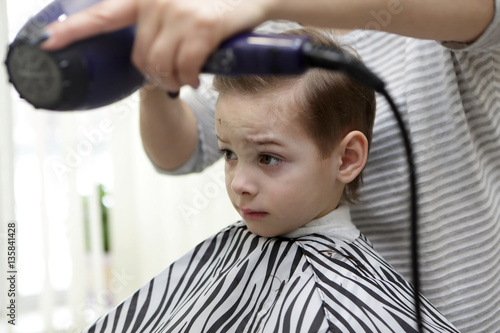 Boy in hairdresser salon