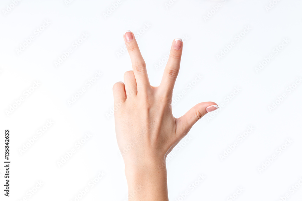 female hand showing the gesture with three fingers female hand showing the gesture with three fingers