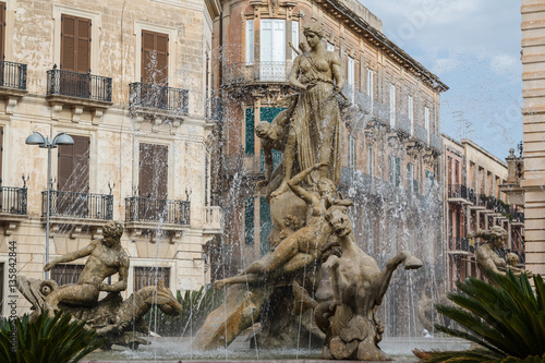 Old fountain in the historic centre of Siracuse, Sicily island,