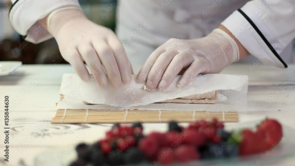 Hands of chef cooking dessert. Sushi with sweet filling. Hands of chef cooking dessert. Sushi with sweet filling.