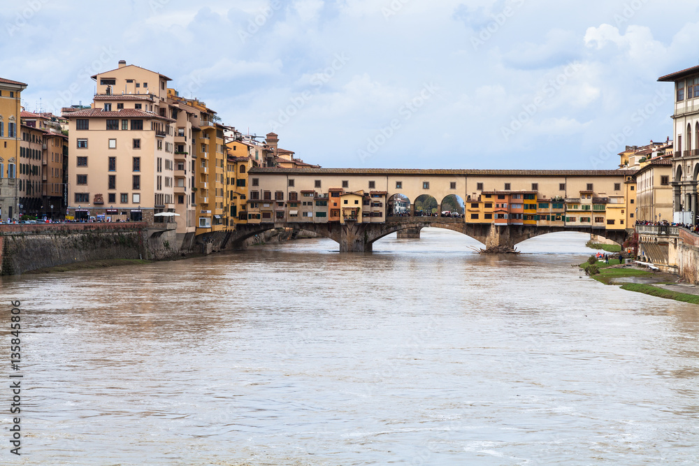 dirty water of Arno and Ponte Vecchio in autumn