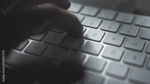 Hands typing on computer keyboard - close-up photo