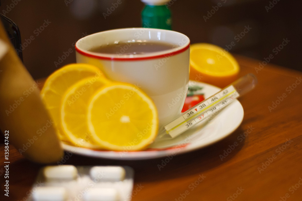 High temperature on the thermometer in the tea background High temperature on the thermometer in the tea background