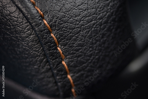 Car leather texture with stitch. Interior detail. Macro photo.