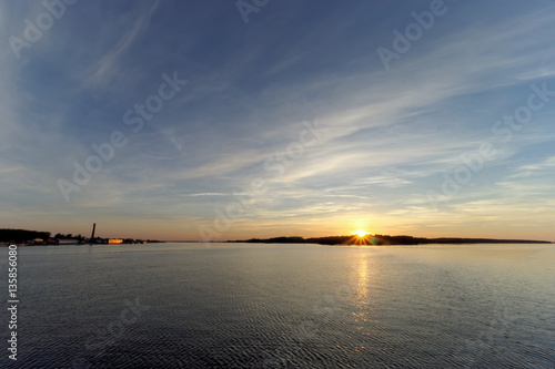 A view of the calm golden sunset on the river with the sun reflected in it, Volga, Russia © vladimirmpetrov