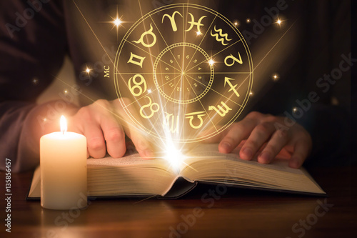 man reading astrology book