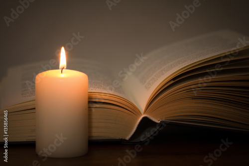 book and burning candle