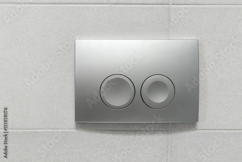 Toilet flushing buttons photo