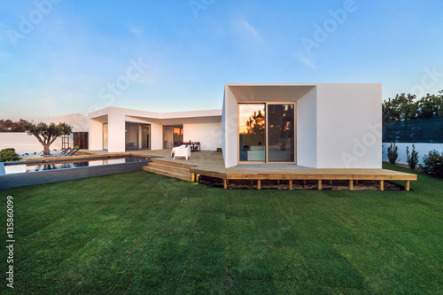 Modern house with garden swimming pool and wooden deck