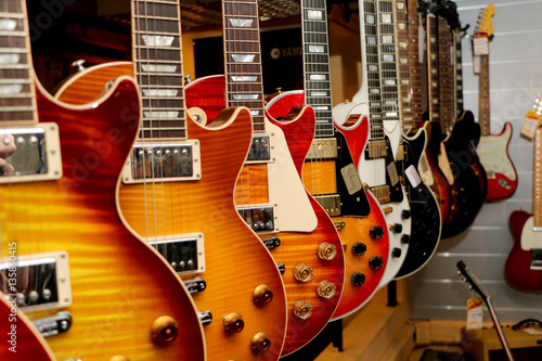 a large number of electric guitars on the counter in the store
