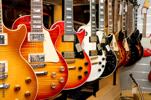 a large number of electric guitars on the counter in the store