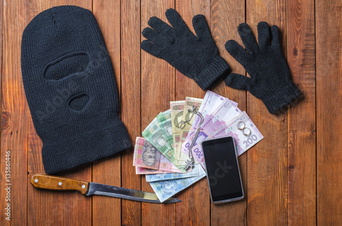 black mask with a gun crime on the table