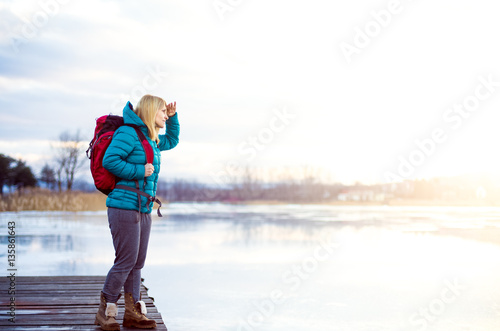 Woman looking over frozen lake