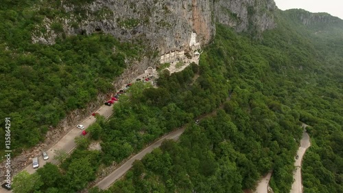 Hairpin road to the upper Ostrog Serbian Orthodox monastery and parking lot for visitors. Aerial view. Montenegro
