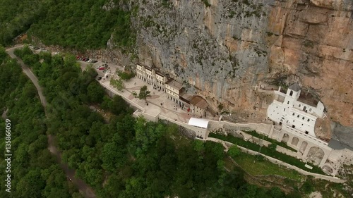 Aerial view at buildings os churches of Ostrog Monastery (the Serbian Orthodox Church) cut in cliff. Montenegro
