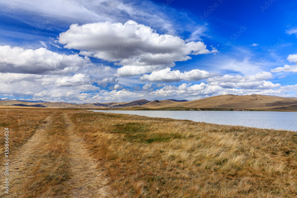 Beautiful steppe mountain landscape with river and clouds. Altai