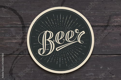 Coaster for beer with hand drawn lettering Beer. Monochrome vintage drawing for bar, pub and beer themes. Black circle for placing a beer mug or a bottle over it with lettering. Vector Illustration photo