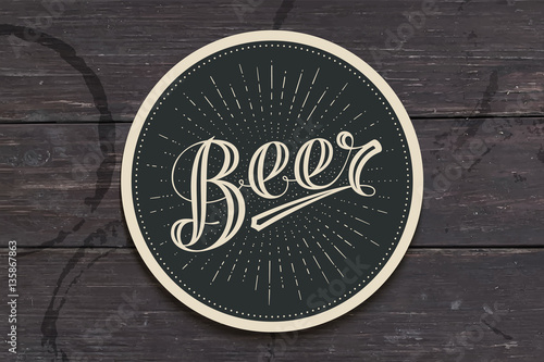 Coaster for beer with hand drawn lettering Beer. Monochrome vintage drawing for bar, pub and beer themes. Black circle for placing a beer mug or a bottle over it with lettering. Vector Illustration