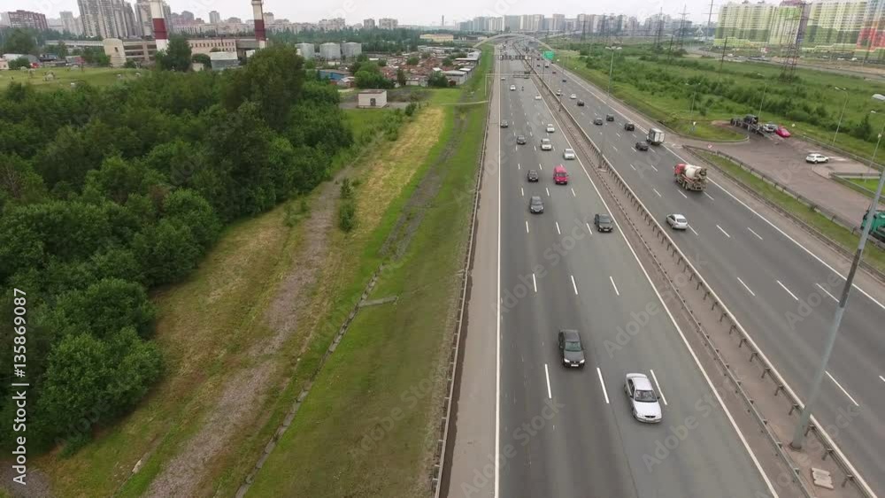 Traffic at the city ring highway. Camera flying across lanes. Transportation of St. Petersburg, Russia
Traffic at the city ring highway. Camera flying across lanes. Transportation of St. Petersburg, Russia