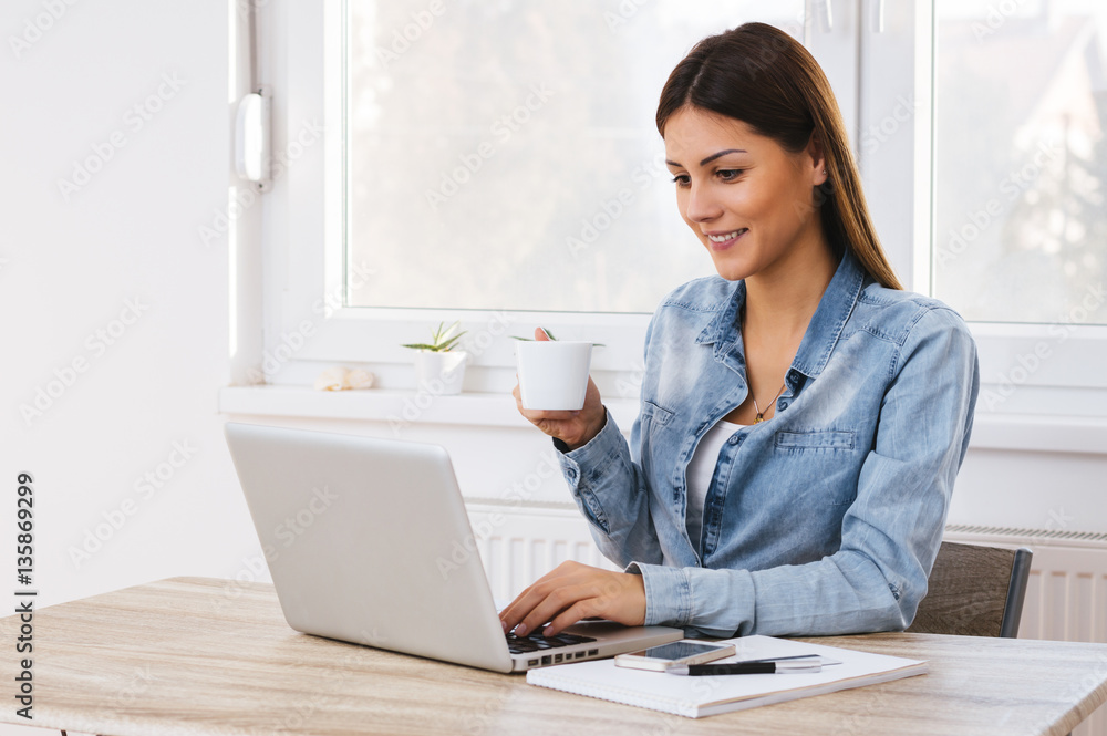 Happy office girl at desk working on laptop Happy office girl at desk working on laptop