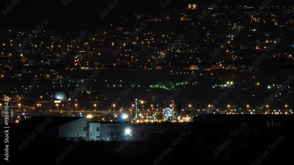Timelapse shot of night city life. View to the electric lights in the darkness. Thessaloniki, Greece Timelapse shot of night city life. View to the electric lights in the darkness. Thessaloniki, Greece