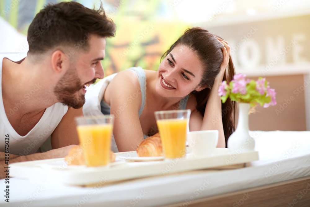 Loving couple having breakfast in the bed