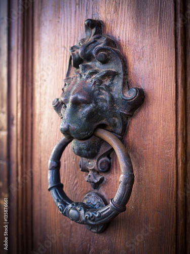 Antique door knocker shaped lion's head.