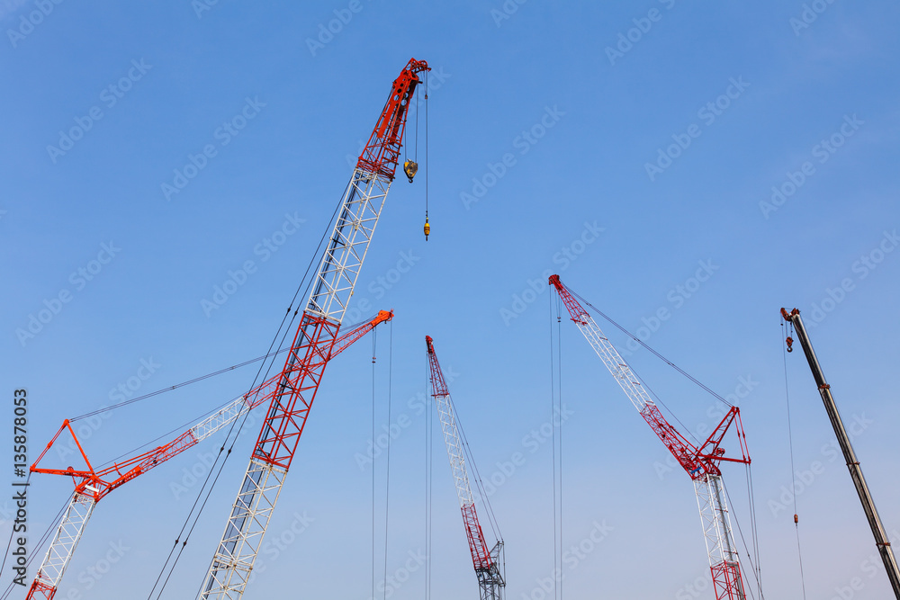 Close - up big red crane at construction site Close - up big red crane at construction site