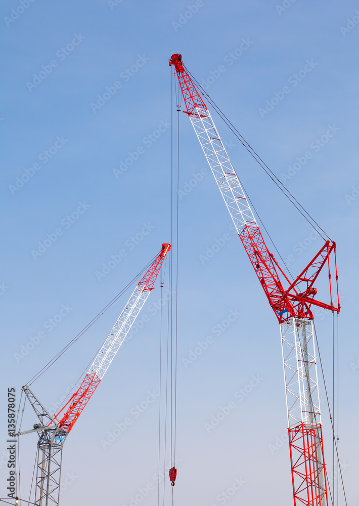 Close - up big red crane at construction site Close - up big red crane at construction site