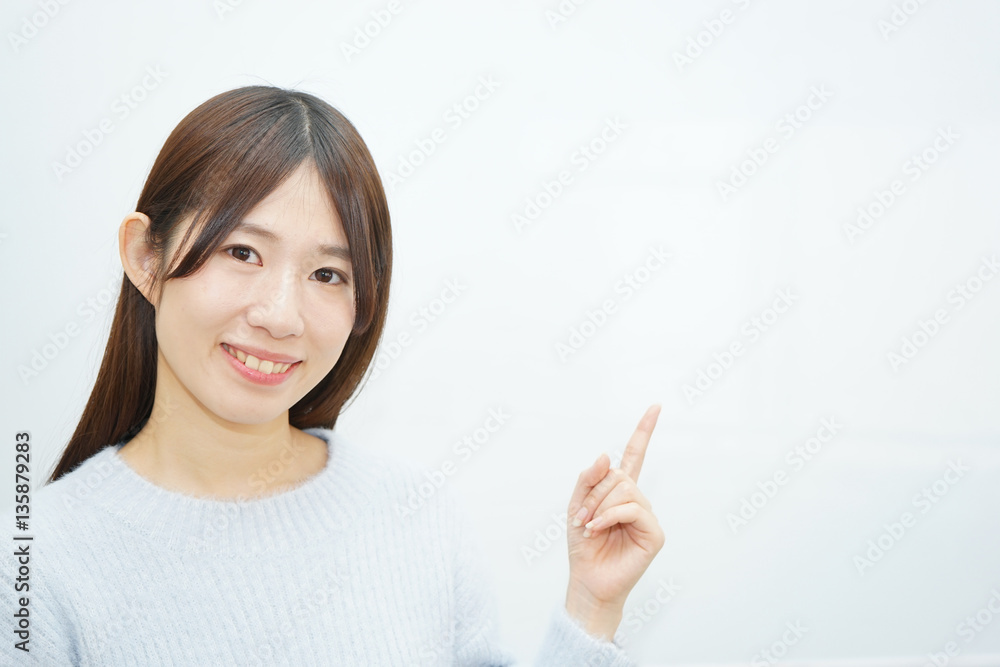 Young woman pointing something with white background Young woman pointing something with white background