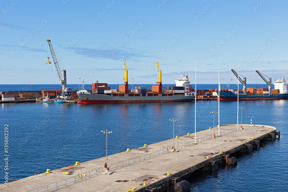 Ponta Delgada port piers, Azores, Portugal. Ocean port on a sunny morning with cargo ships.