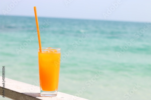 Tropical orange cocktail on the sea background