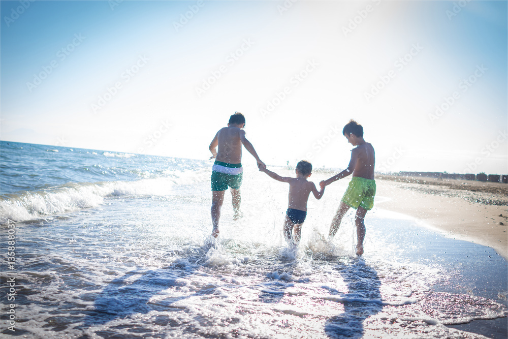 Fun kids playing splash at beach Fun kids playing splash at beach