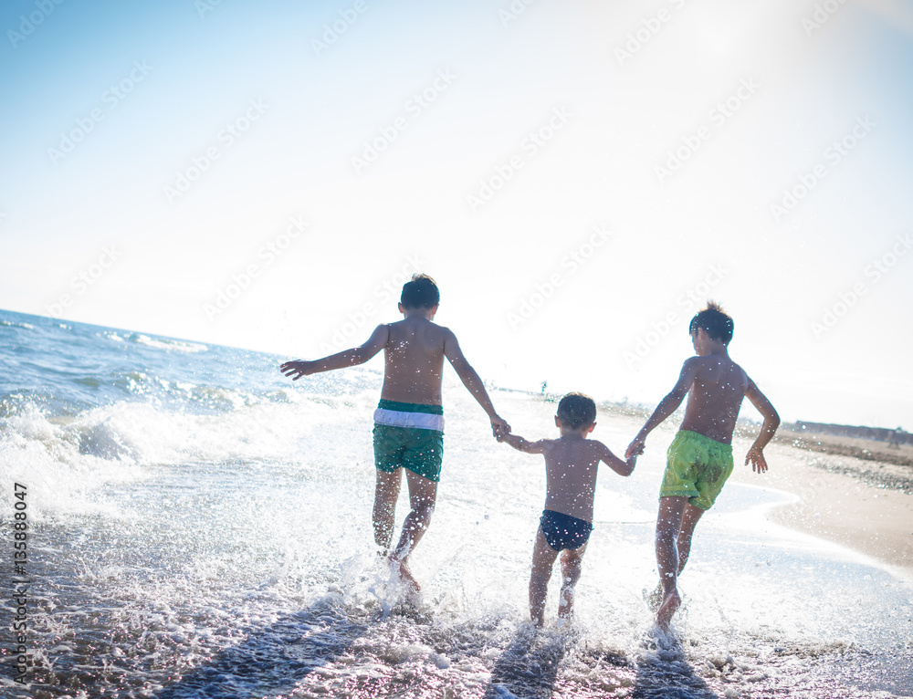 Fun kids playing splash at beach Fun kids playing splash at beach