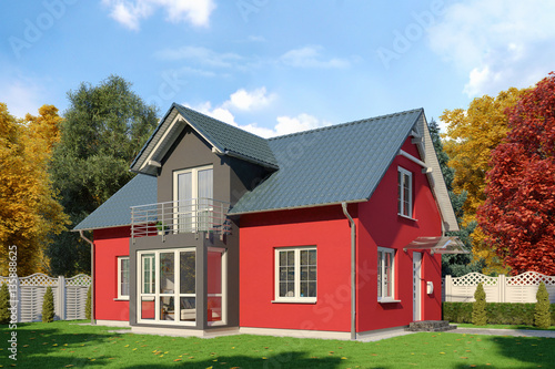 Ein rot-schwarzes Einfamilienhaus in blühender Natur im Herbst am Tag.