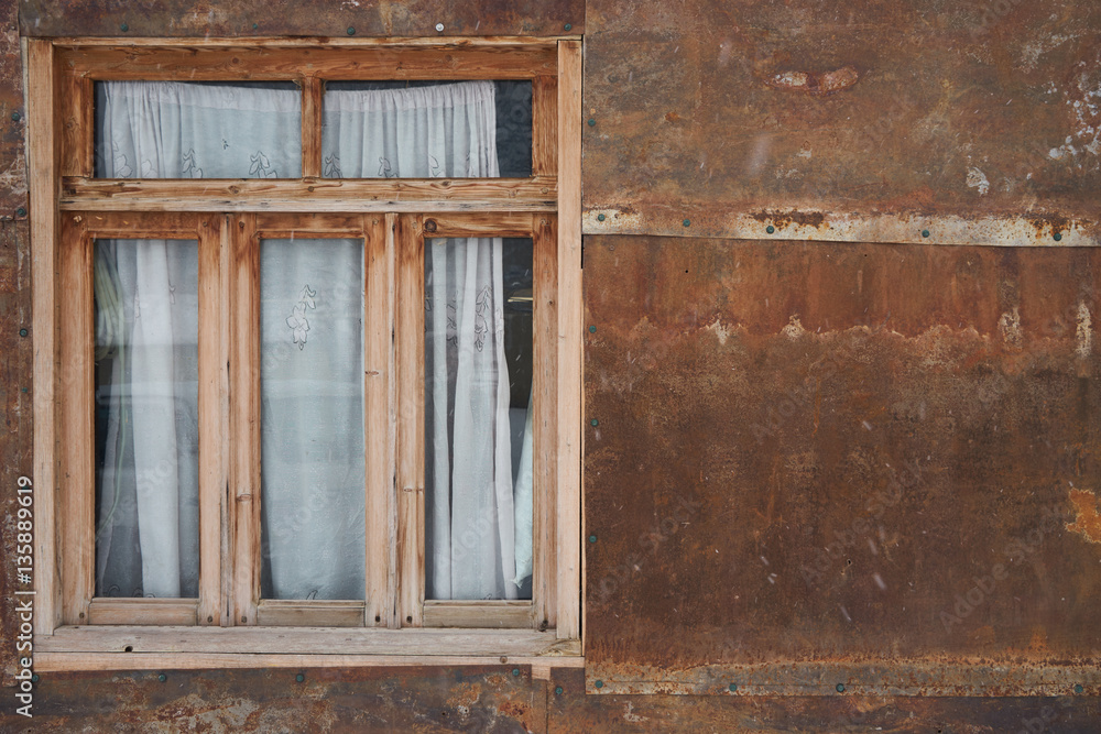 Old rustic wooden window and brown grungy wall. Copy space Old rustic wooden window and brown grungy wall. Copy space