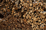 Firewood stacked in a woodpile.background