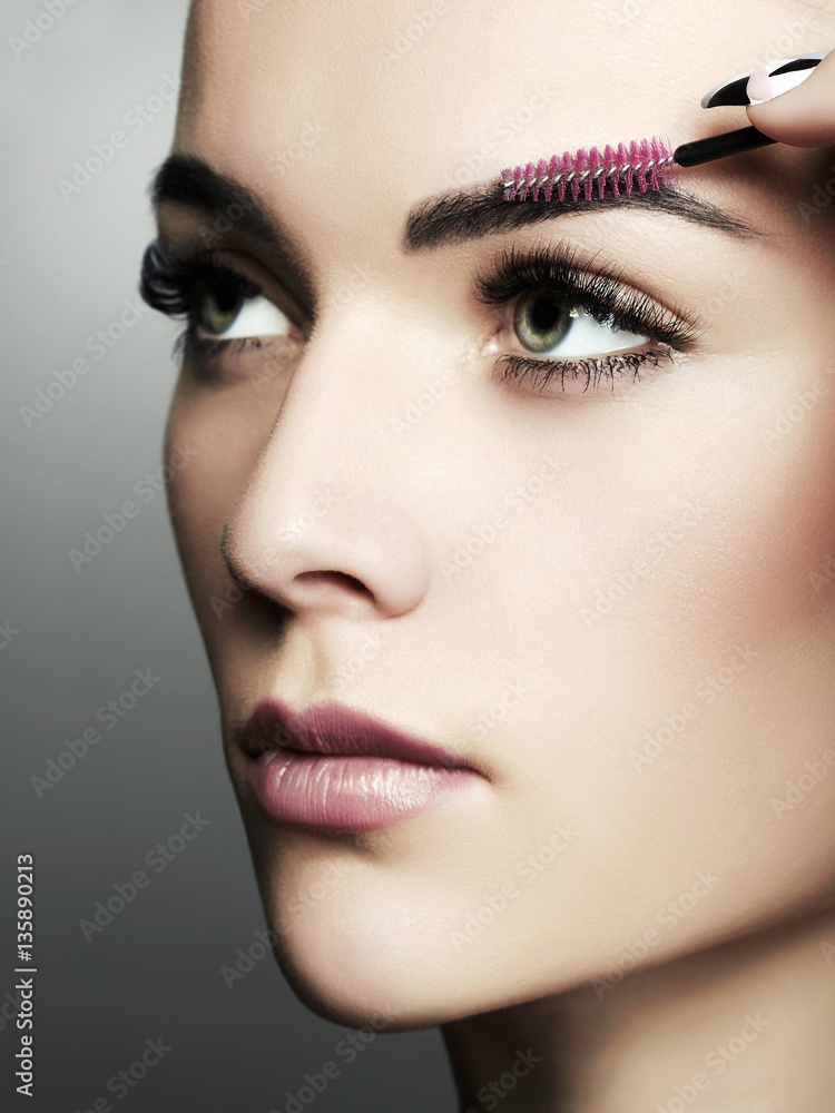 beautiful young woman doing make-up