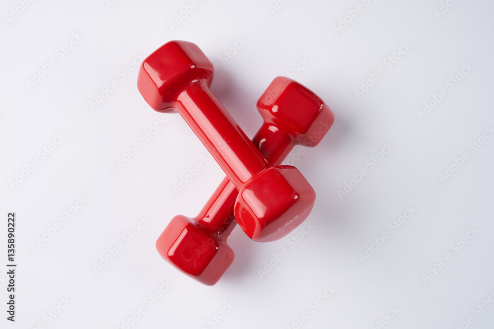 Top view of red dumbbells on white background. Fitness concept Top view of red dumbbells on white background. Fitness concept